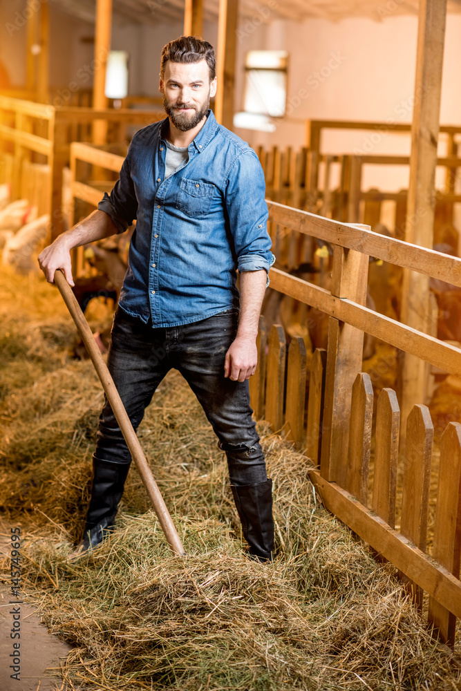 Farmer working in the goat barn