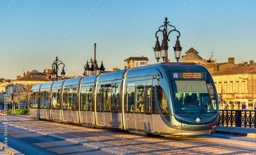 City tram on Pont de Pierre bridge in Bordeaux, France