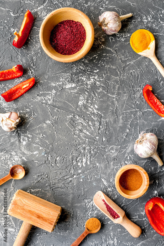 Professional kitchen with spices for cook on gray background top view mock-up