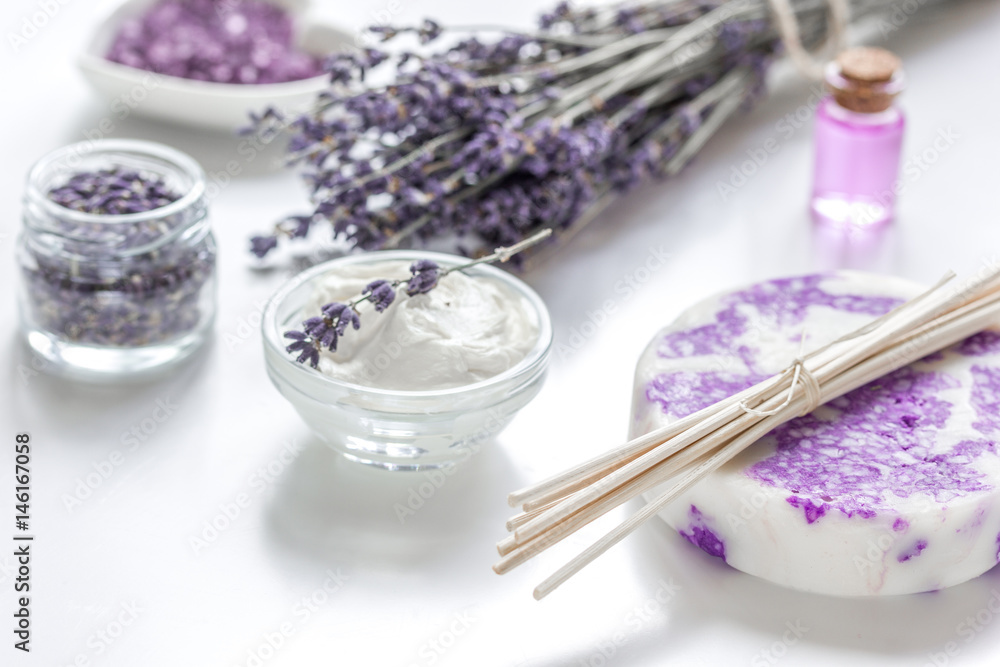 lavender herbs in body care cosmetics with oil on white table background