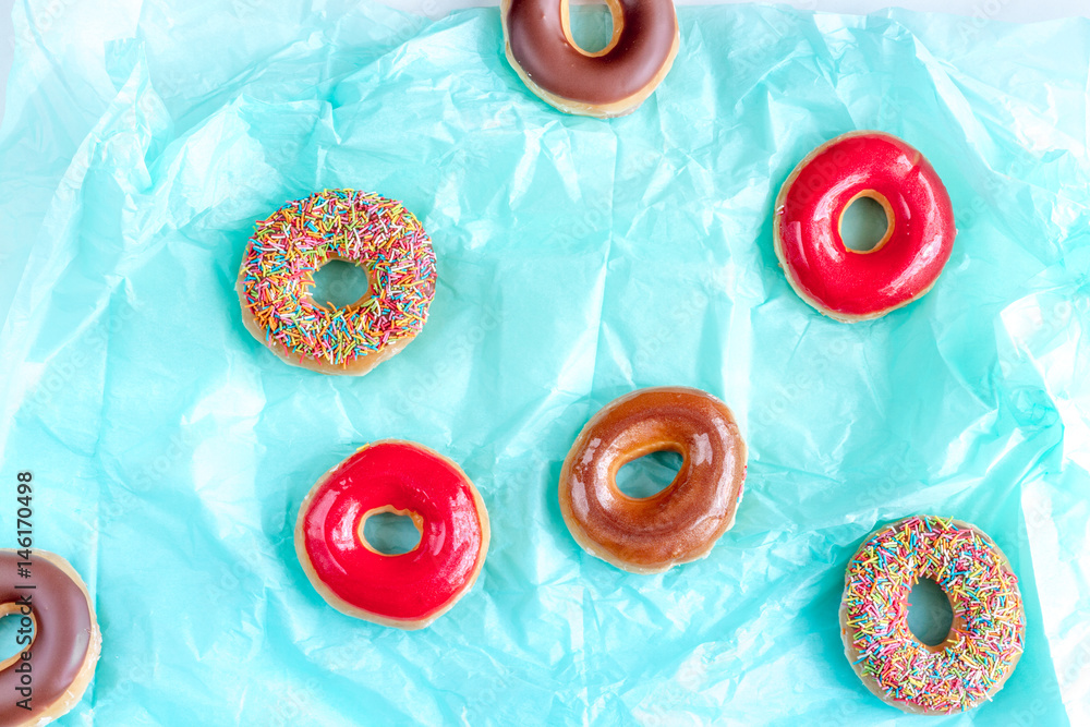 food design with chocolate donat on blue paper background top view pattern