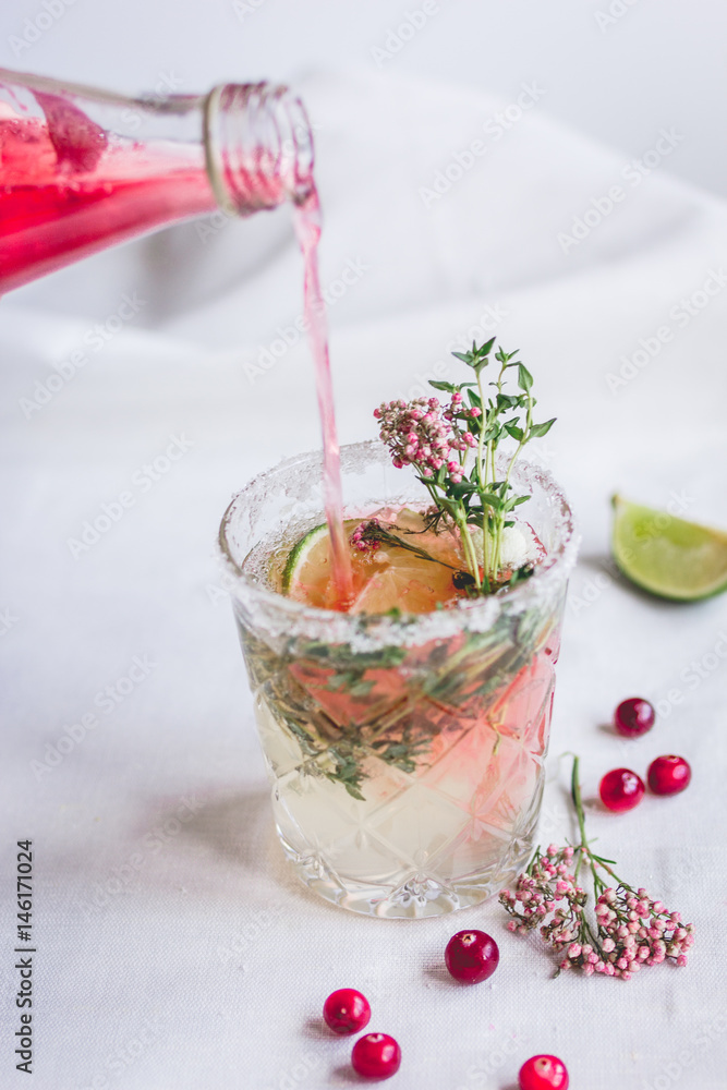 summer homemade juice with lime and berries on stone table background