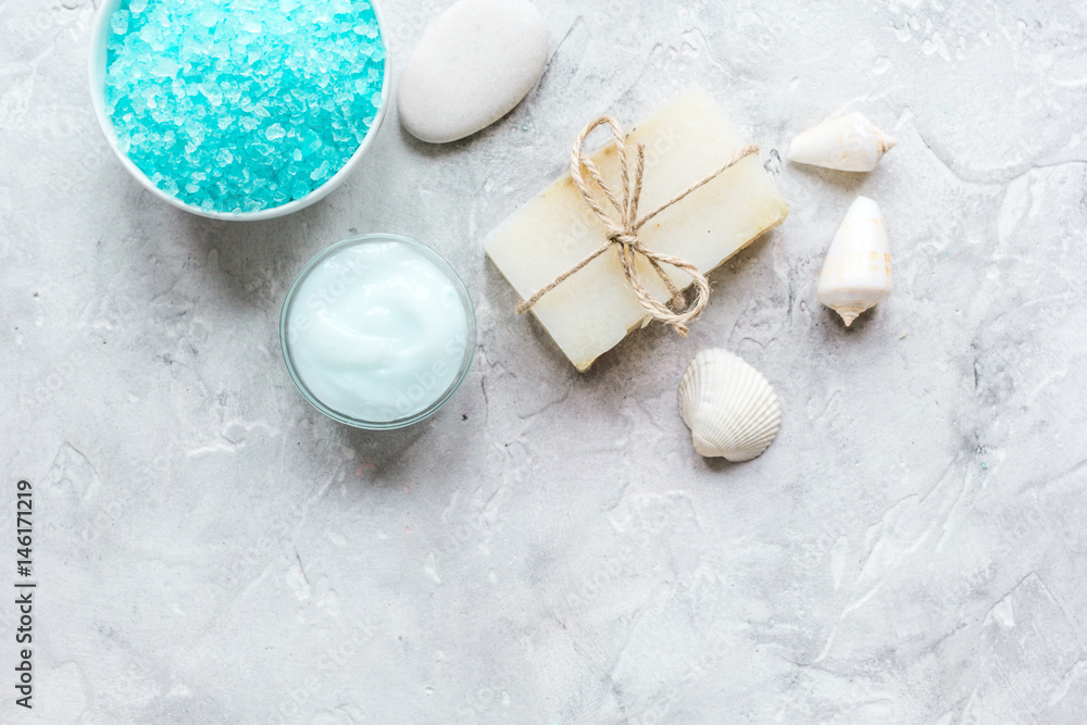 Home cosmetic with cream and sea salt on stone background top view mock-up