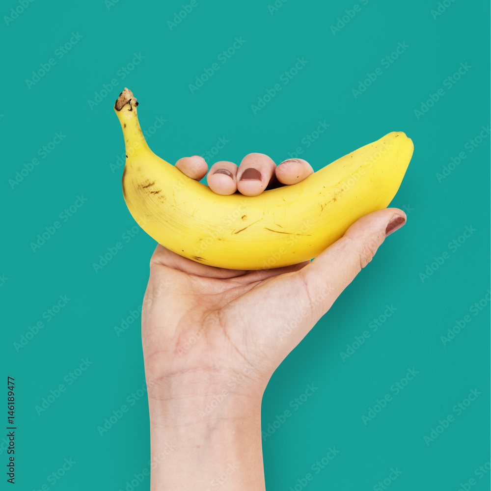 Human Hand Holding Banana Fruit Nutrition Concept