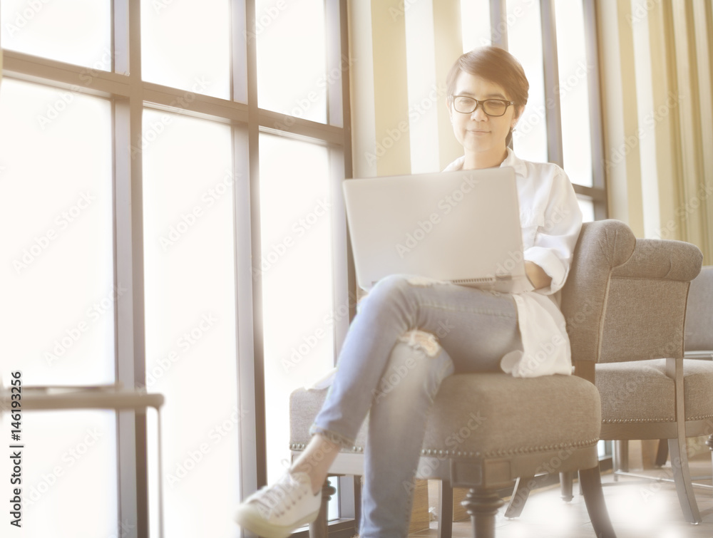 Businesswoman working in office with laptop computer