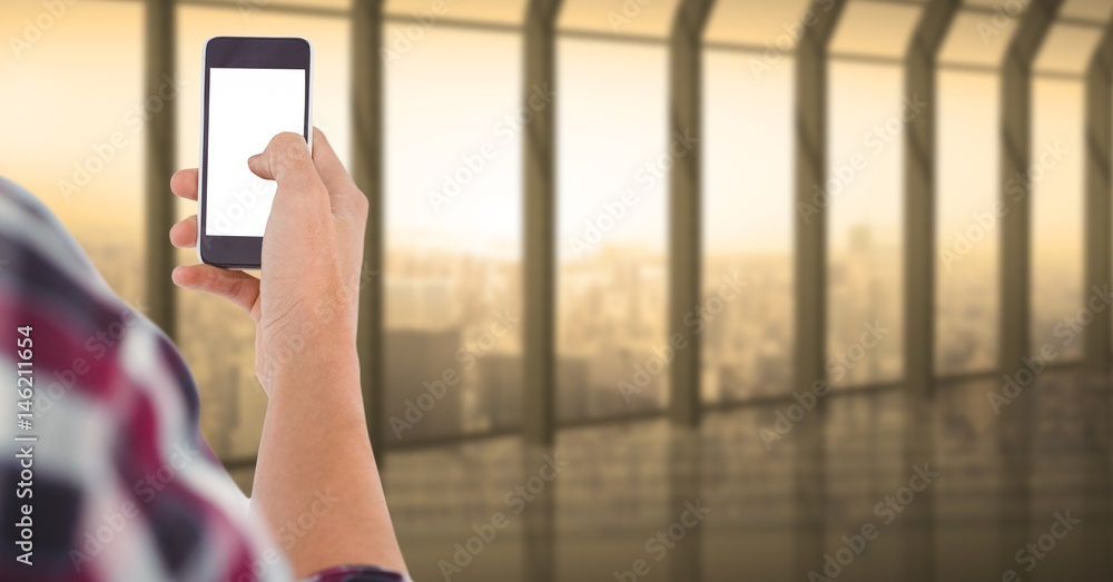 Person touching blank screen of smart phone in office