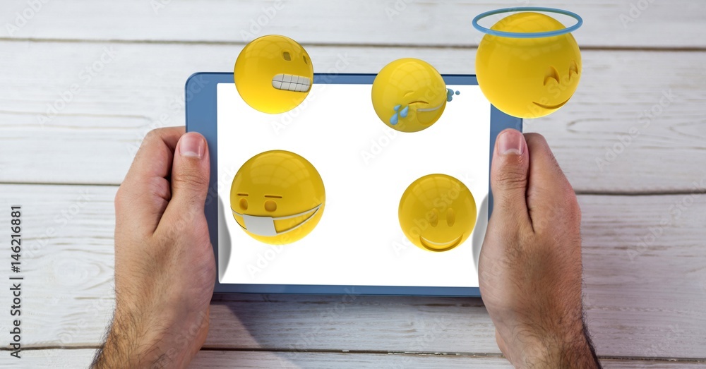 Emojis flying out from tablet PC held by man