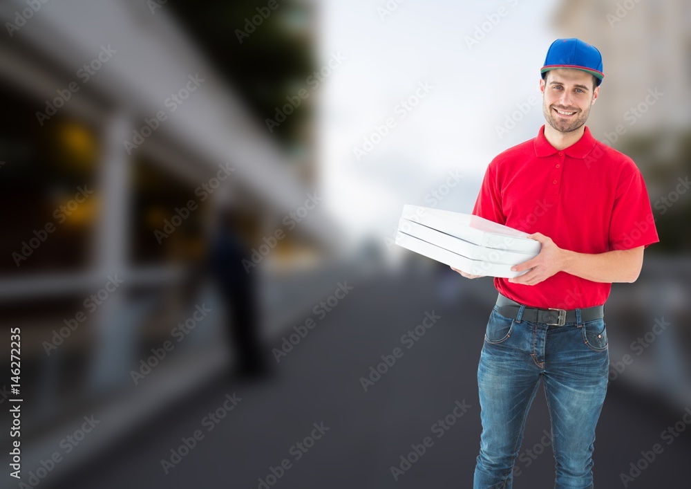 Happy deliveryman with pizza boxes in a bridge