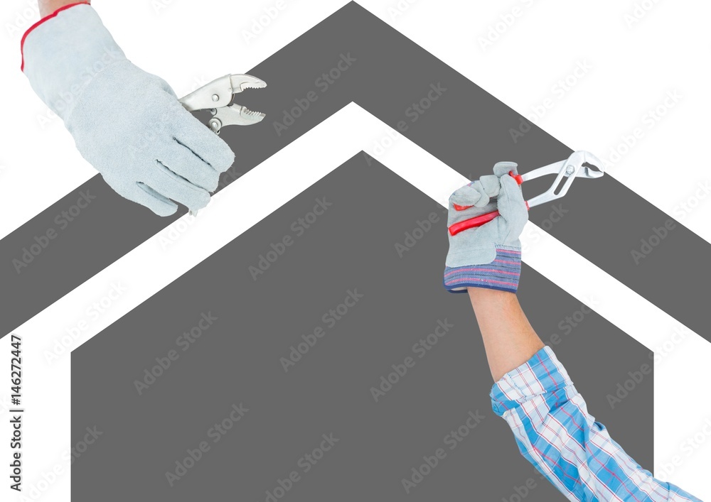 hands with tools on grey house background