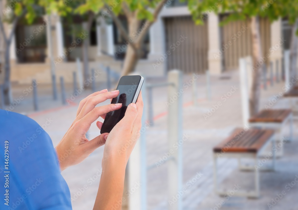 hands with phone in the park