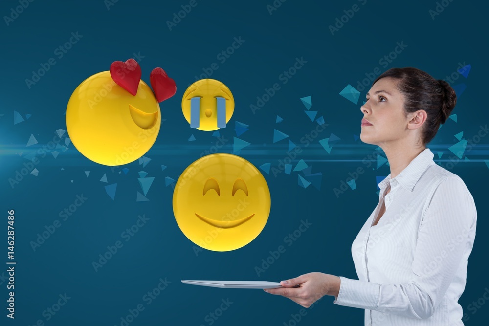 Composite image of businesswoman using a tablet