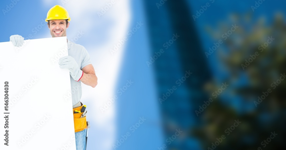 Worker wearing hardhat while holding blank bill board