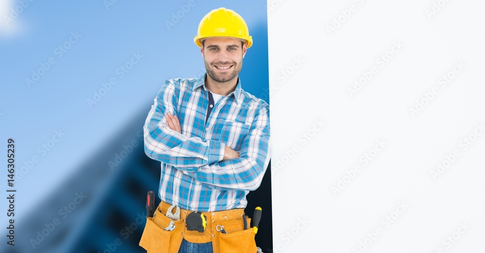 Carpenter with arms crossed leaning on blank bill board