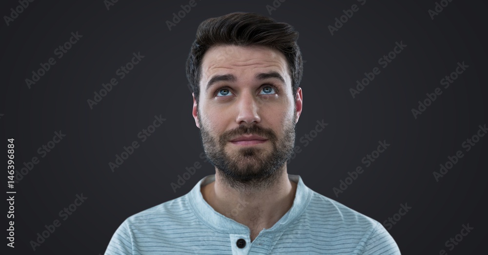 Man looking up against dark grey background