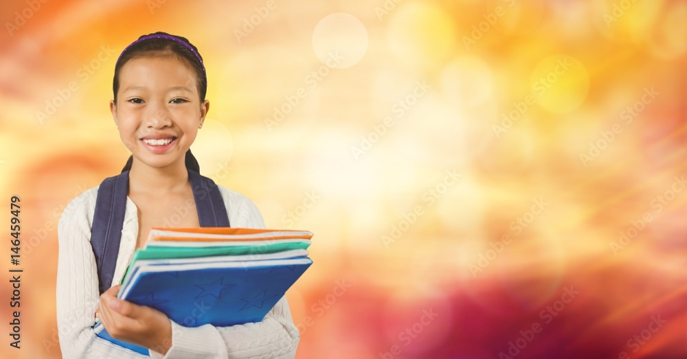 Happy school girl holding books