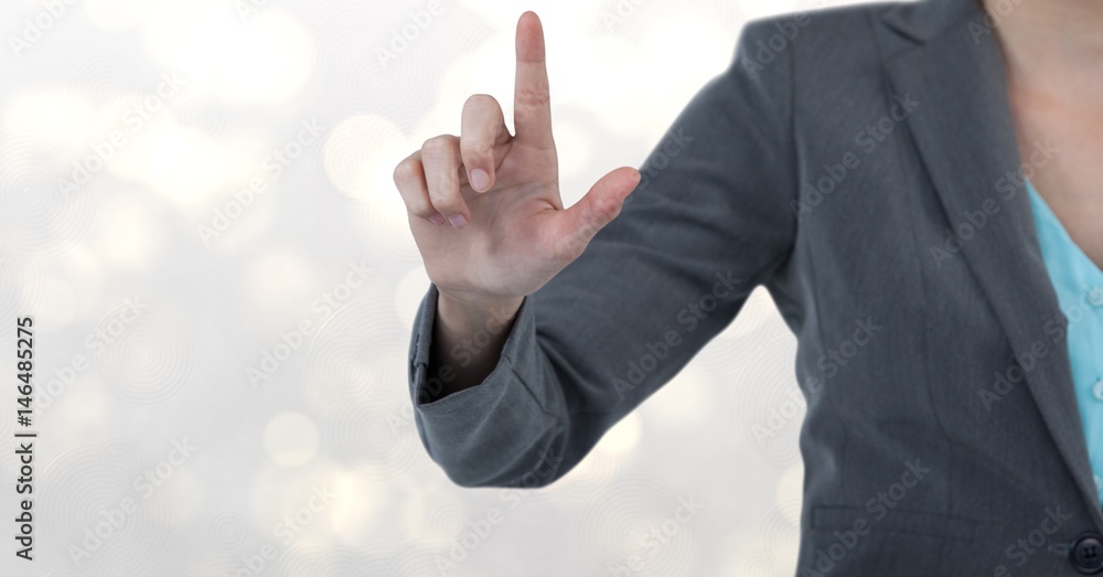 Midsection of businesswoman touching screen