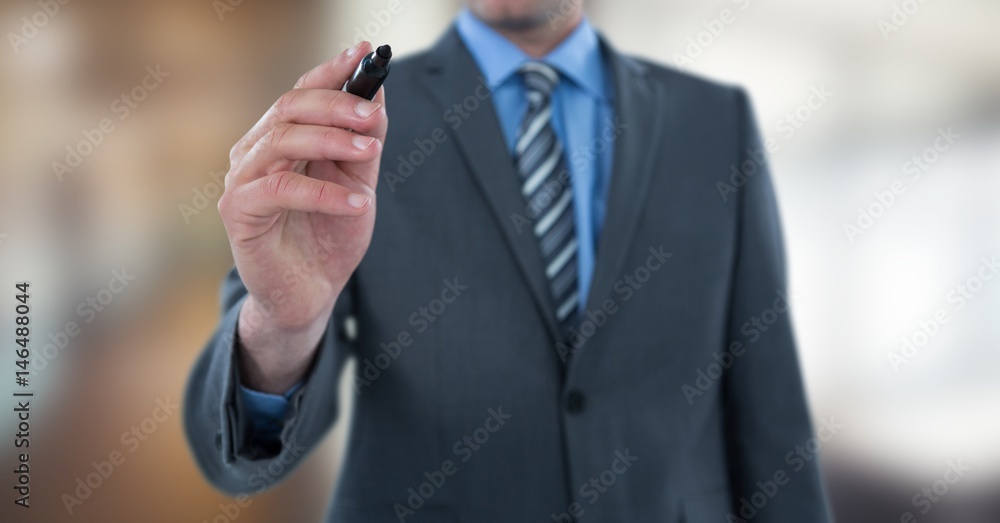 Midsection of businessman using felt tip pen