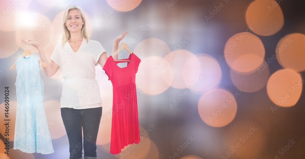 Smiling woman choosing dress over bokeh