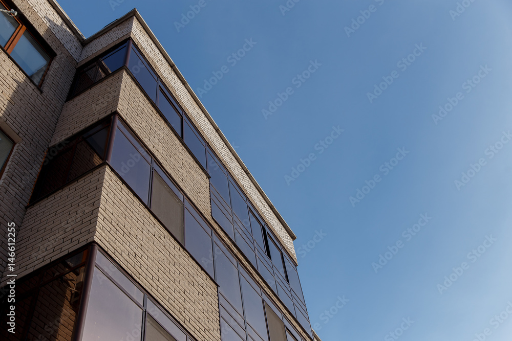 The new multi-storey residential building against blue sky.