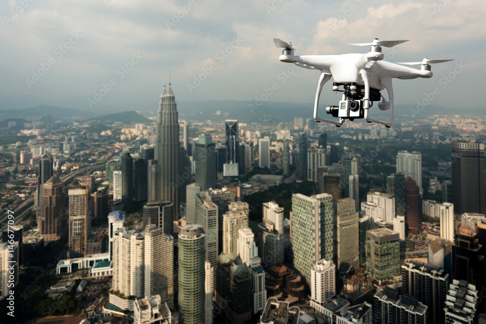 Drone with high resolution digital camera flying over Kuala Lumpur city at Kuala Lumpur, Malaysia.