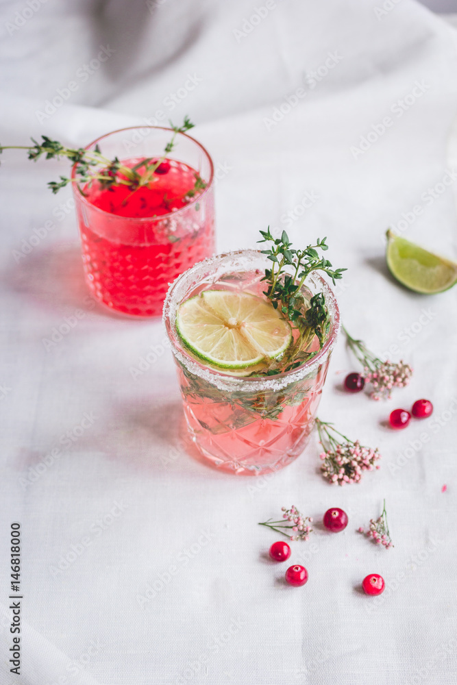 summer homemade juice with lime and berries on stone table background