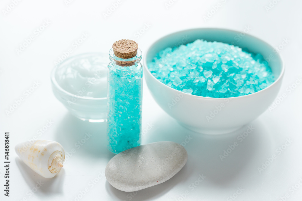 spa composition with blue sea salt and natural soap on white desk background