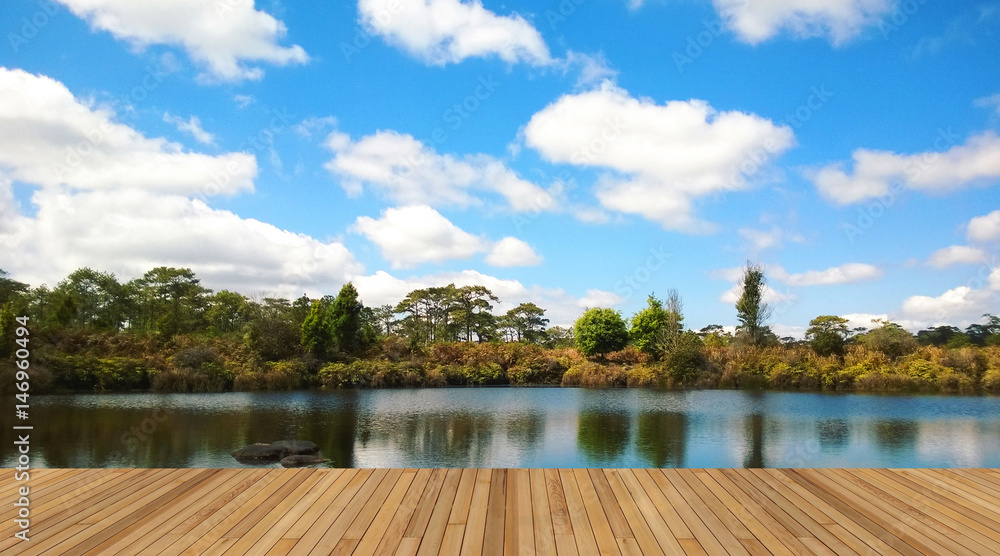 Wooden deck with beautiful lake and blue sky