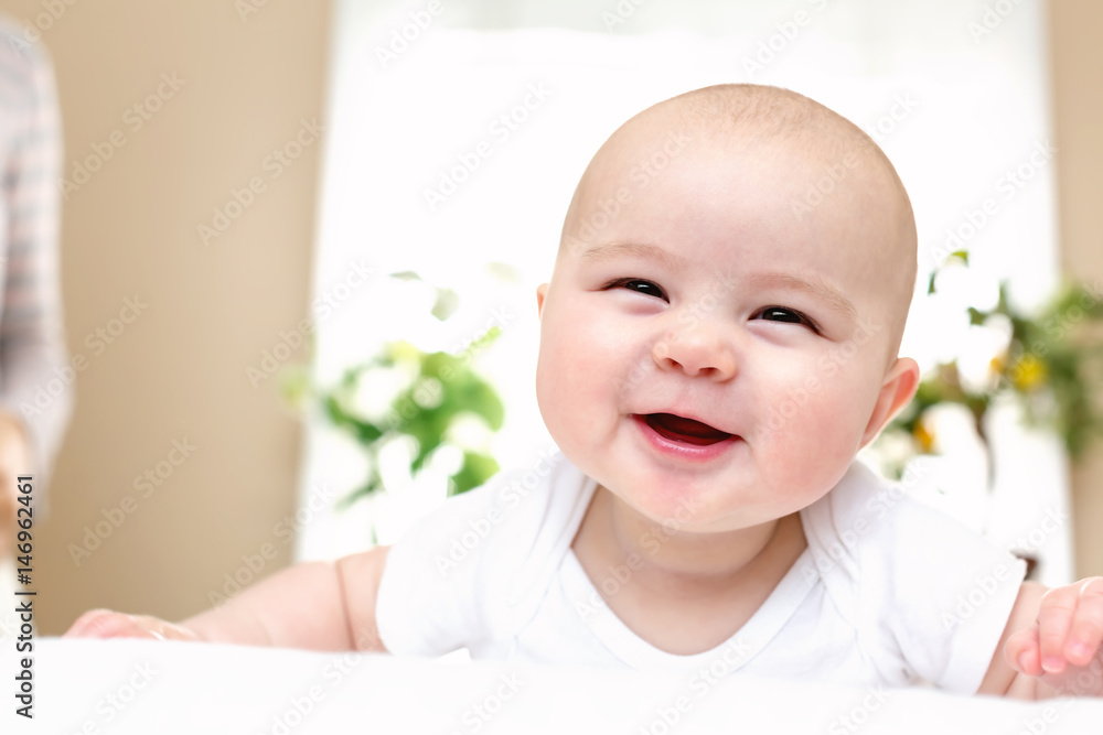 Happy newborn baby girl smiling