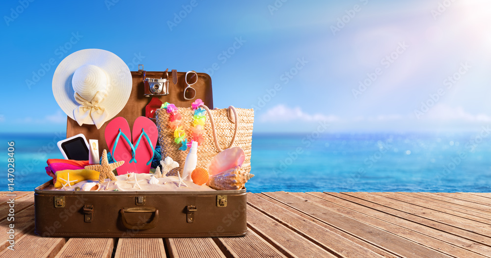 Beach Accessories In Suitcase On Beach - Travel Concept
