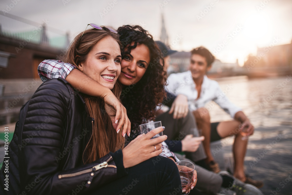 Friends hanging out at lake together