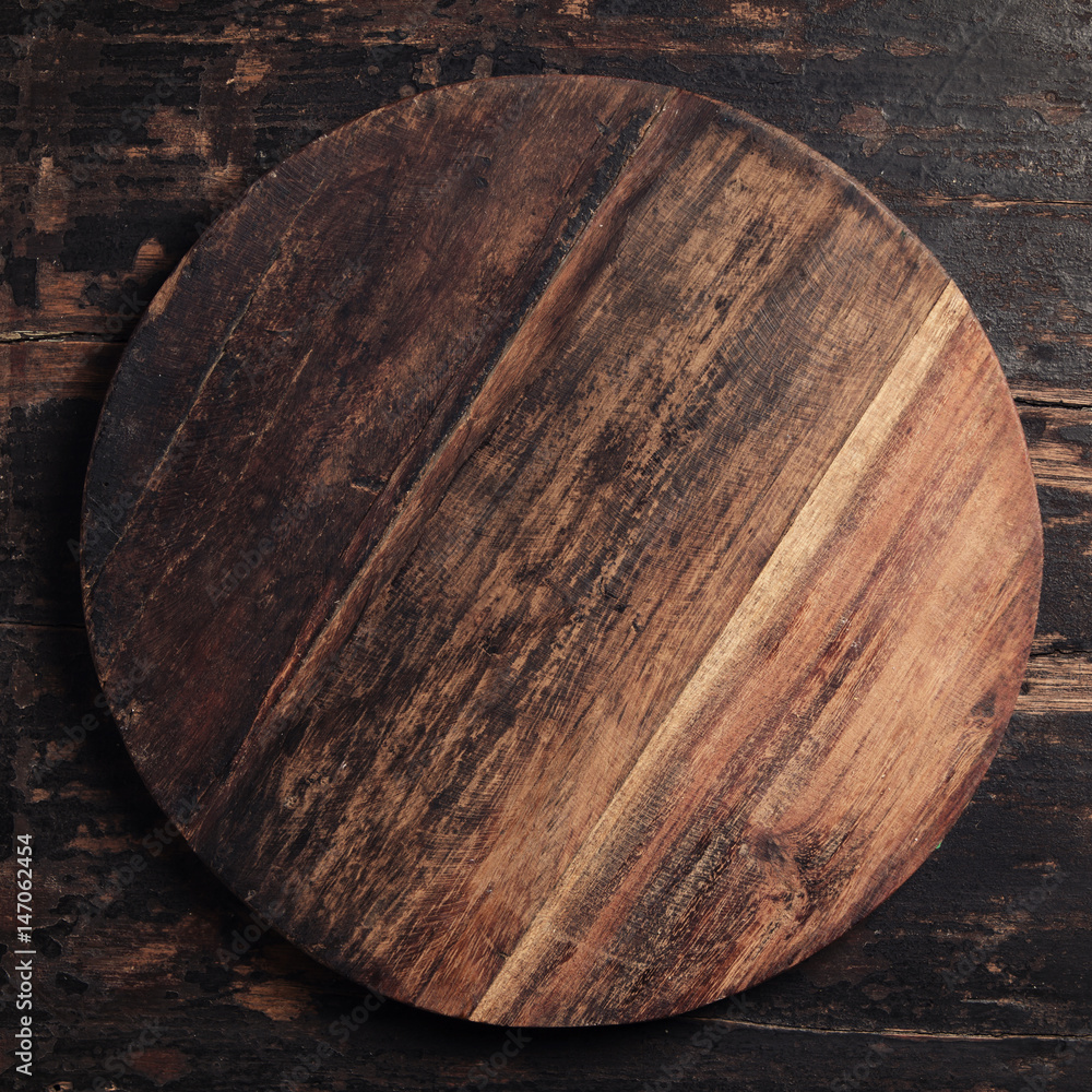 Wooden cutting board on rustic background