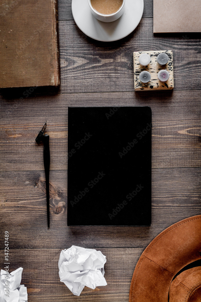 Writer workplace with tools on wooden background top view