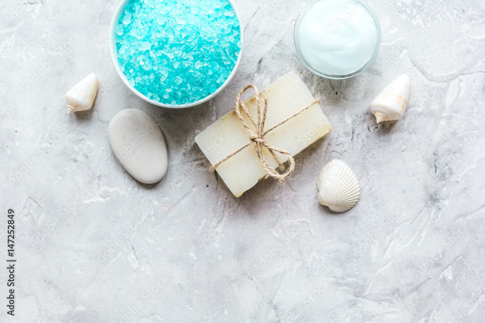 blue salt, body cream and shells for spa bath background top view mockup