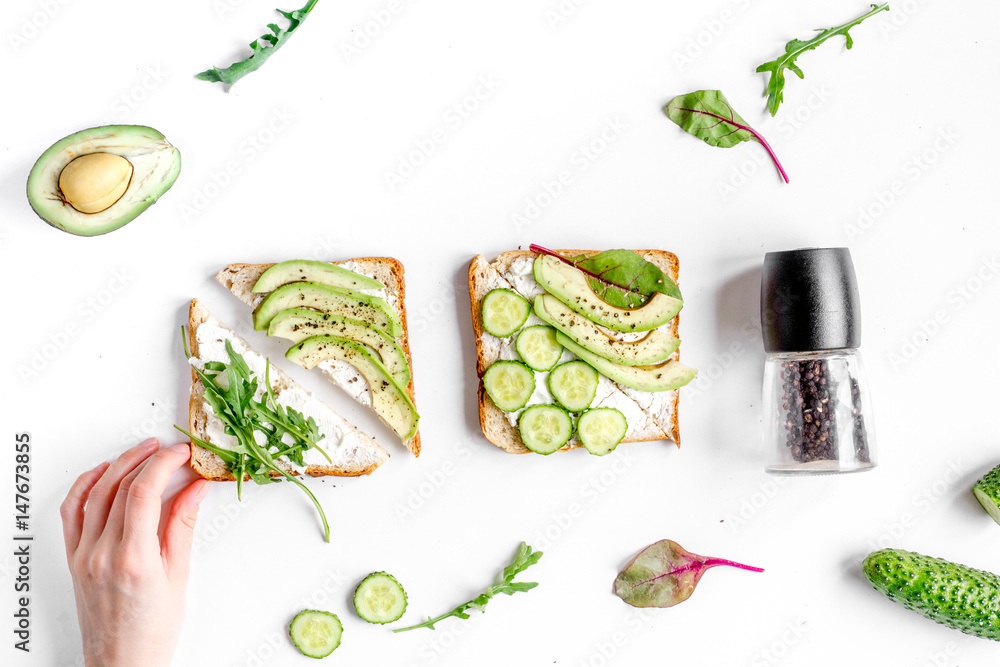 sandwiches set and hands on white table background top view