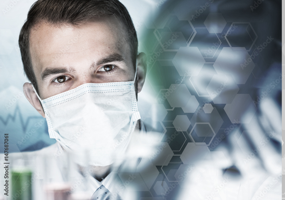 Young scientist mixing reagents in glass flask in clinical laboratory