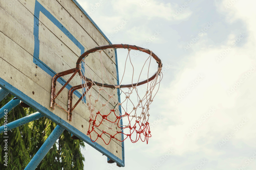 Old basketball hoop in the park.