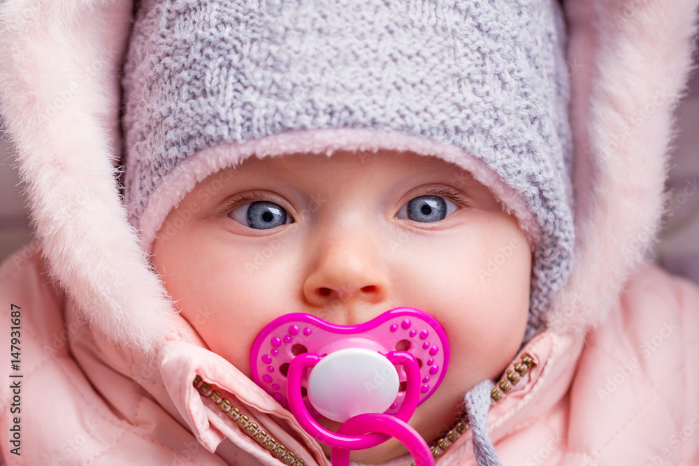 Portrait of baby girl in winter jacket and hat