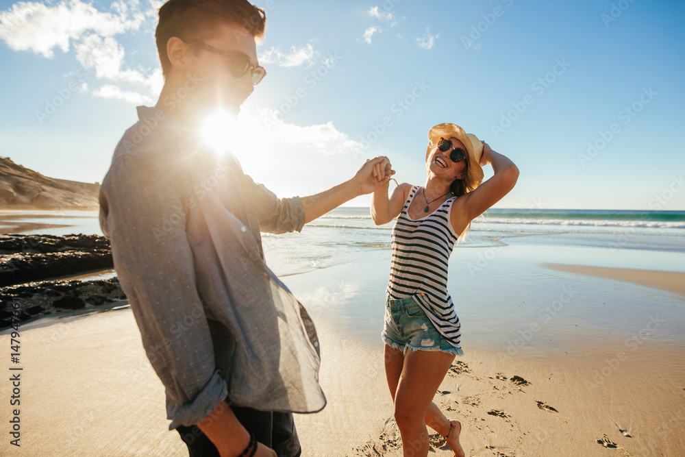 Beautiful young couple having fun on the beach