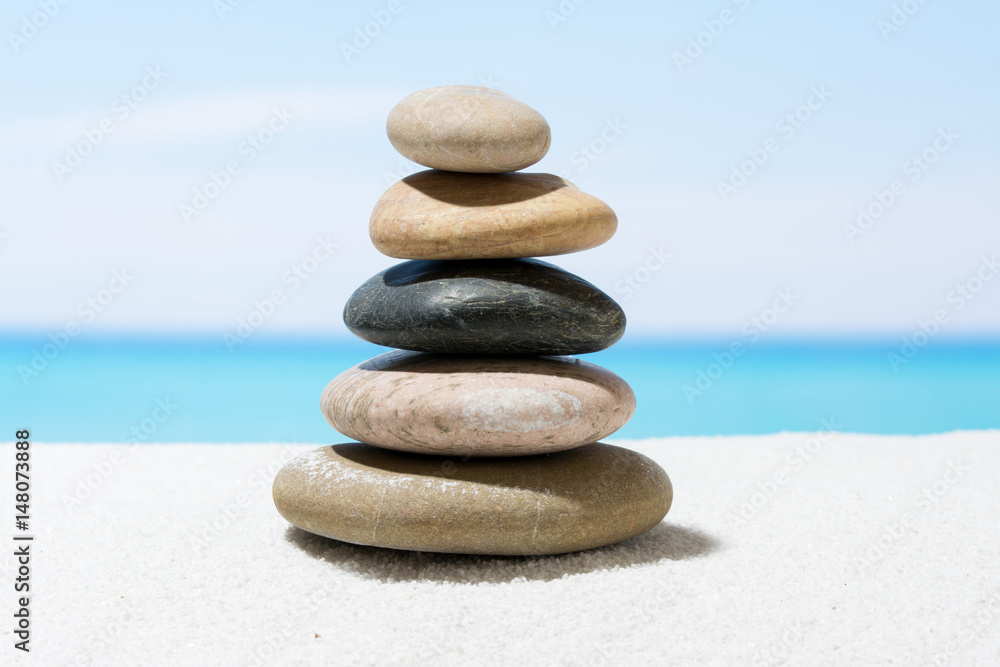 Relaxing in the tropical beach, with white sand and stack of stones