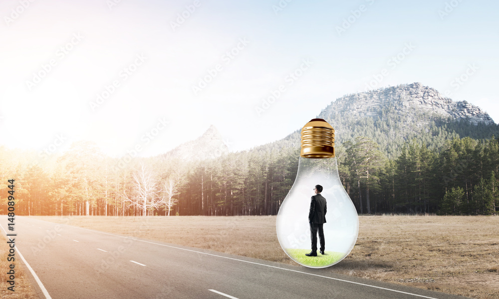 Businessman inside light bulb