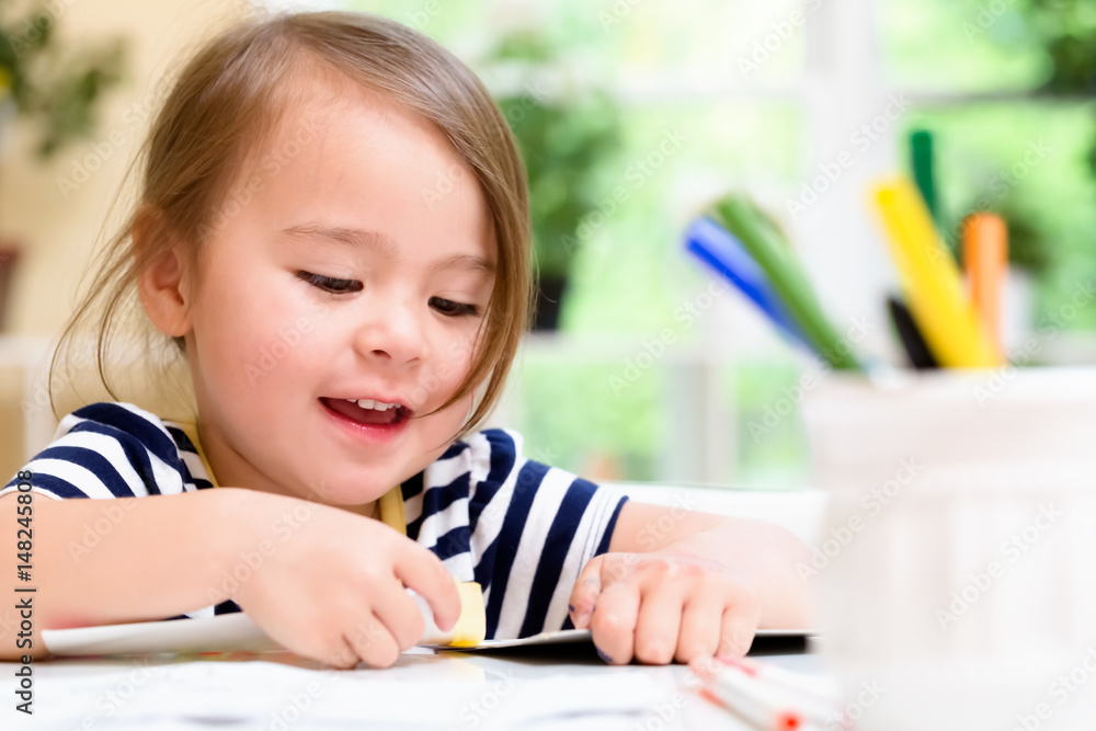 Toddler girl drawing and doing crafts