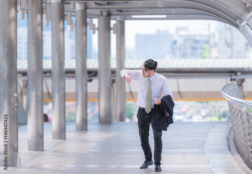 businessman in a hurry checking time and running, he is late for work his business appointment