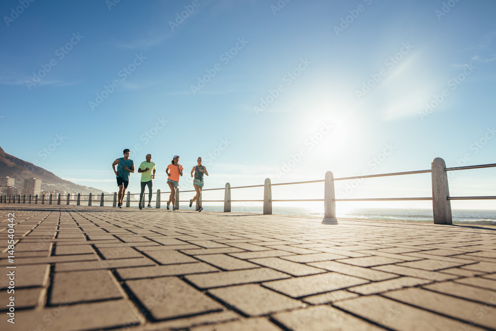 Young people running on ocean water front