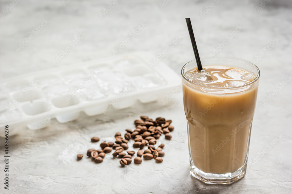 iced coffee with beans for cold summer drink on stone background