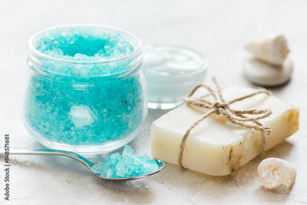 blue spa composition with blue sea salt and natural soap on stone desk background