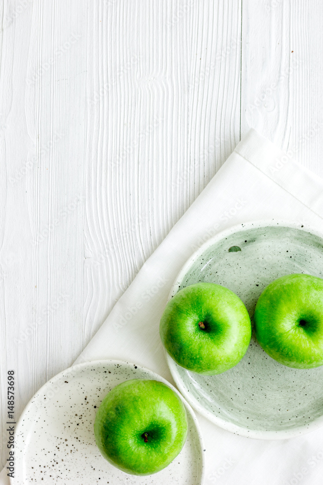 Healthy green food with apples on plates white background top view mock up