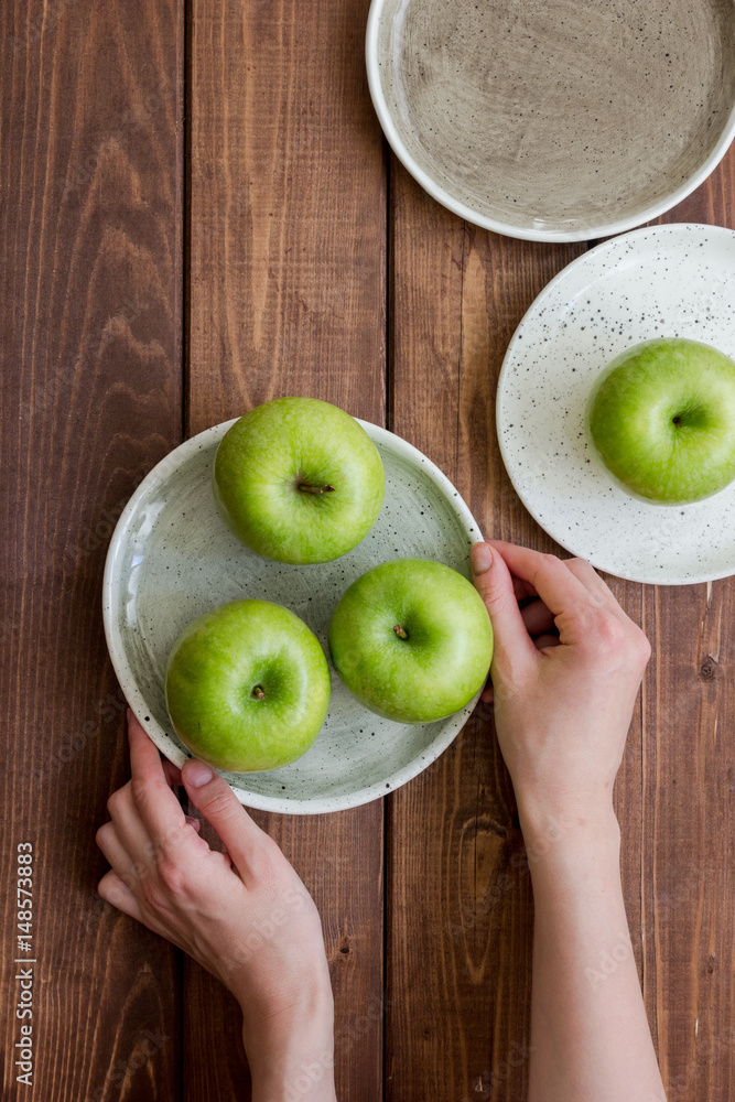 summer food with green apples on wooden background top view