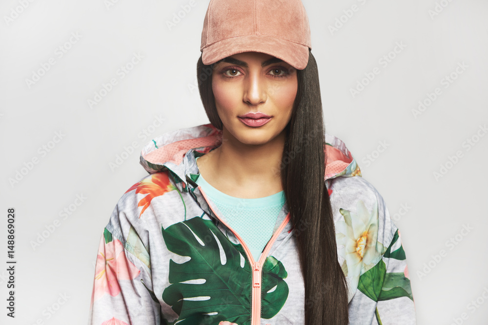 Woman in sports jacket and cap