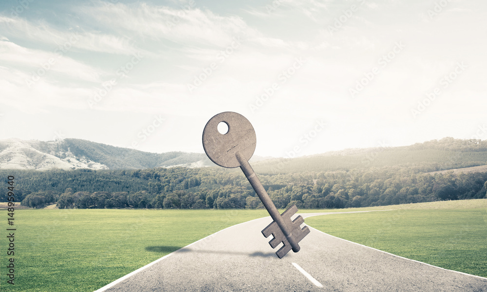 Conceptual background image of concrete key sign on asphalt road