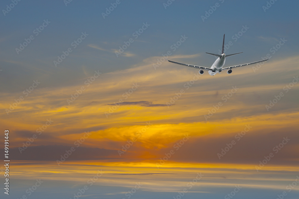 Airplane in the colorful sunrise sky background.